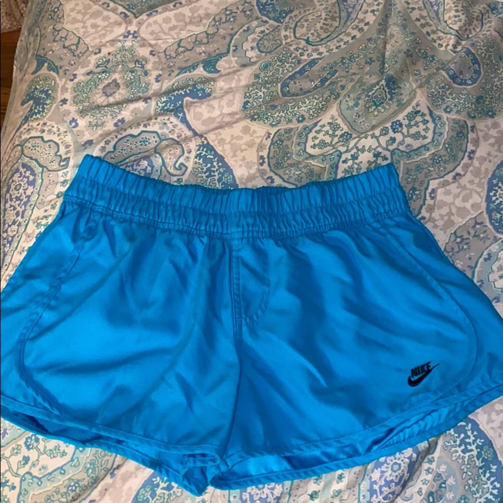 Blue Nike running shorts
